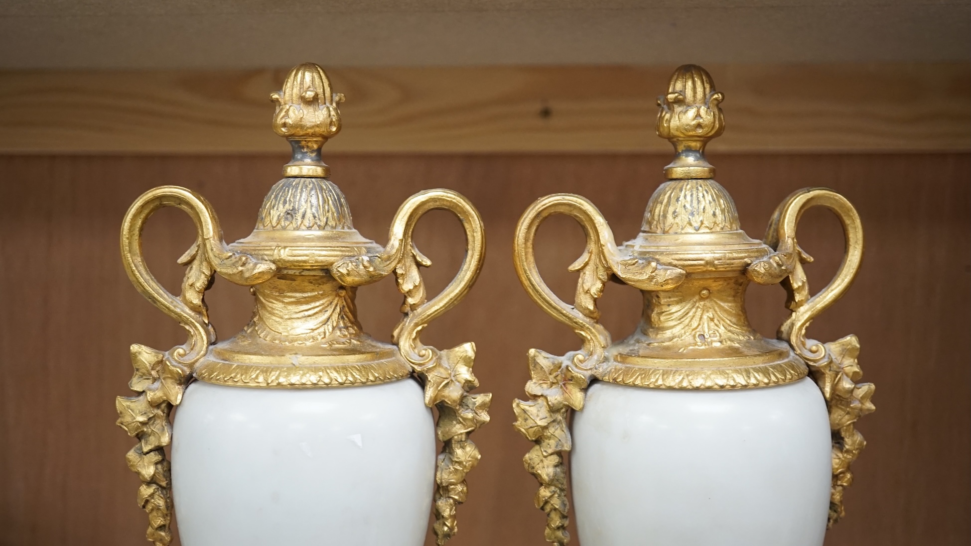 A pair of early 20th century white marble and gilt metal garnitures, 32cm. Condition - worn